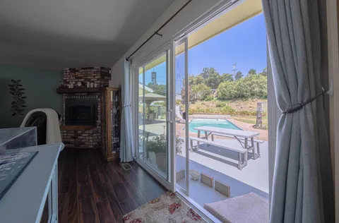 a view of a floor to ceiling window and wooden floor