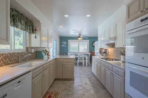 a kitchen with lots of counter top space sink and center island