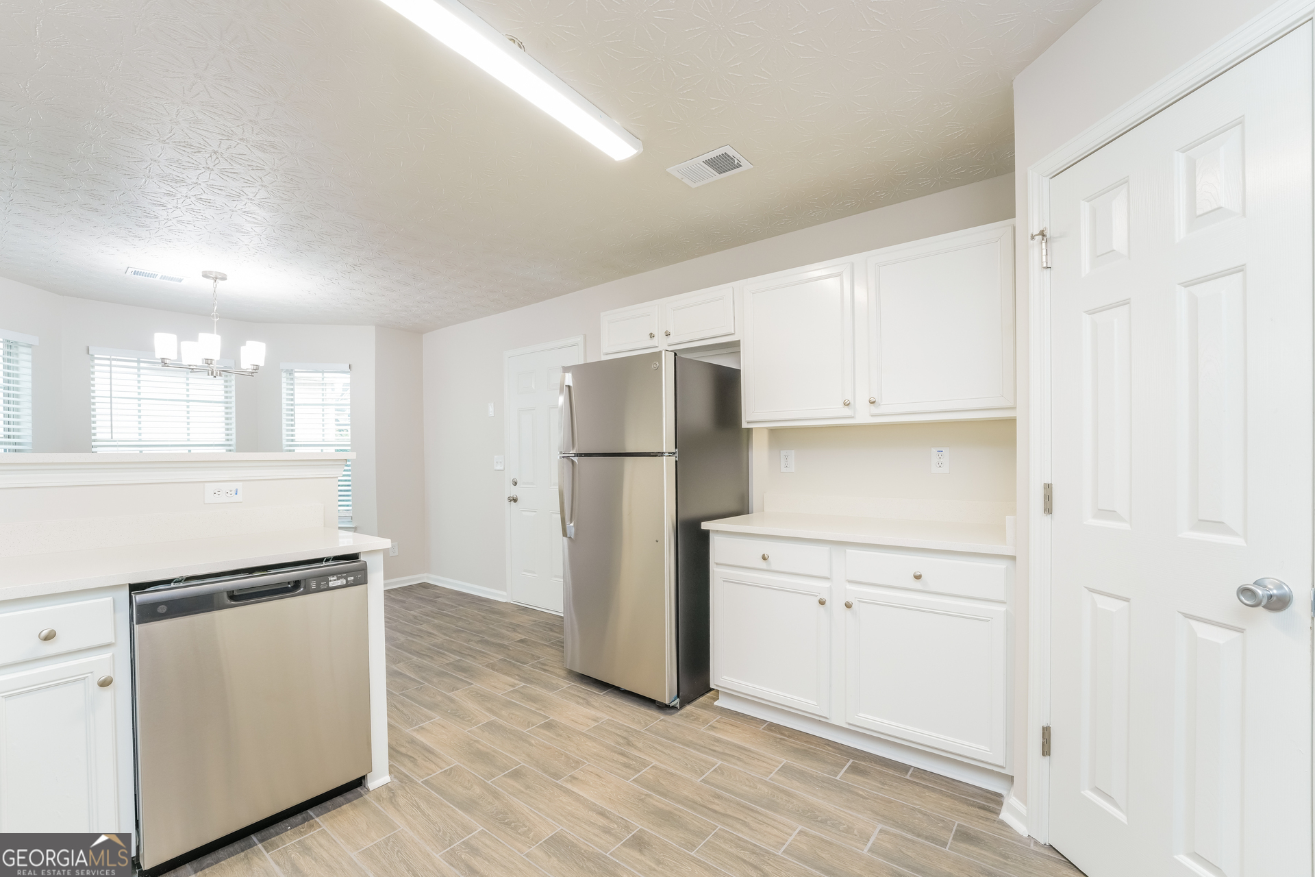 15 Emerson Trail Covington, GA 30016 - Photo 6 of 17 a kitchen with white cabinets and refrigerator
