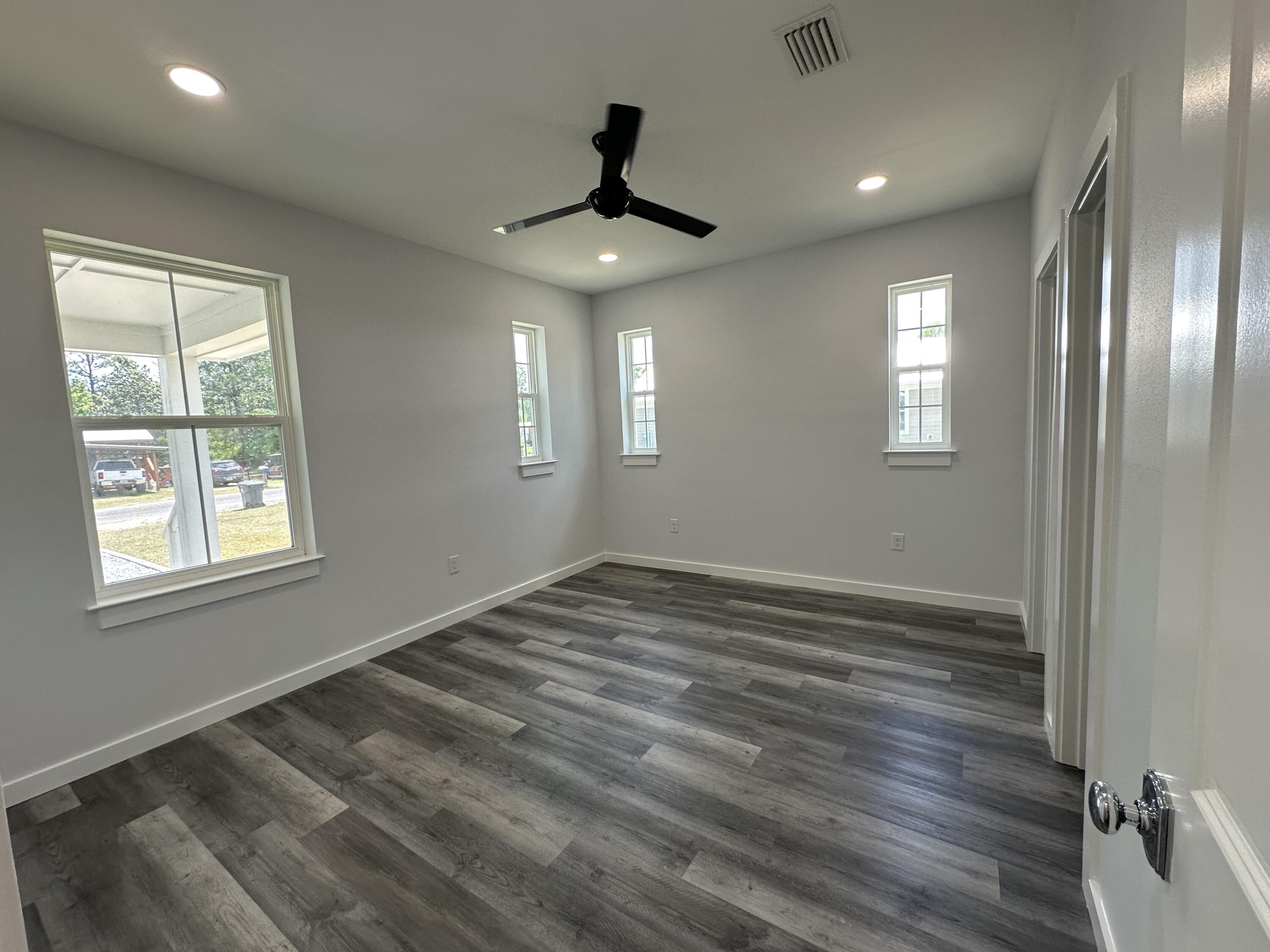 534 North Raphael Road DeFuniak Springs, FL 32433 - Photo 12 of 20 a view of an empty room with wooden floor and a window