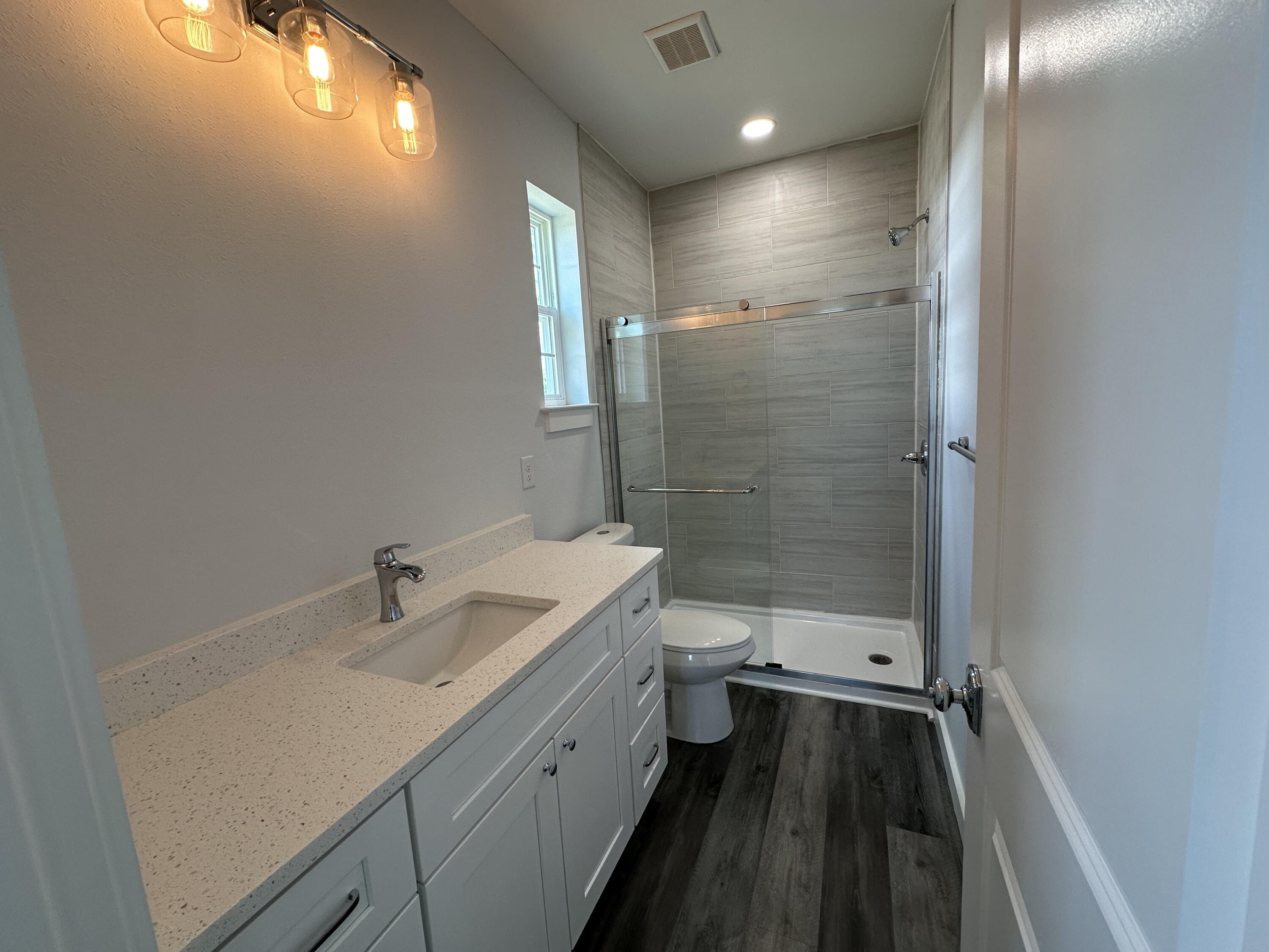 534 North Raphael Road DeFuniak Springs, FL 32433 - Photo 14 of 20 a bathroom with a sink a toilet a shower and a mirror