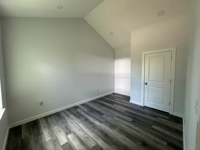 a view of an empty room and wooden floor