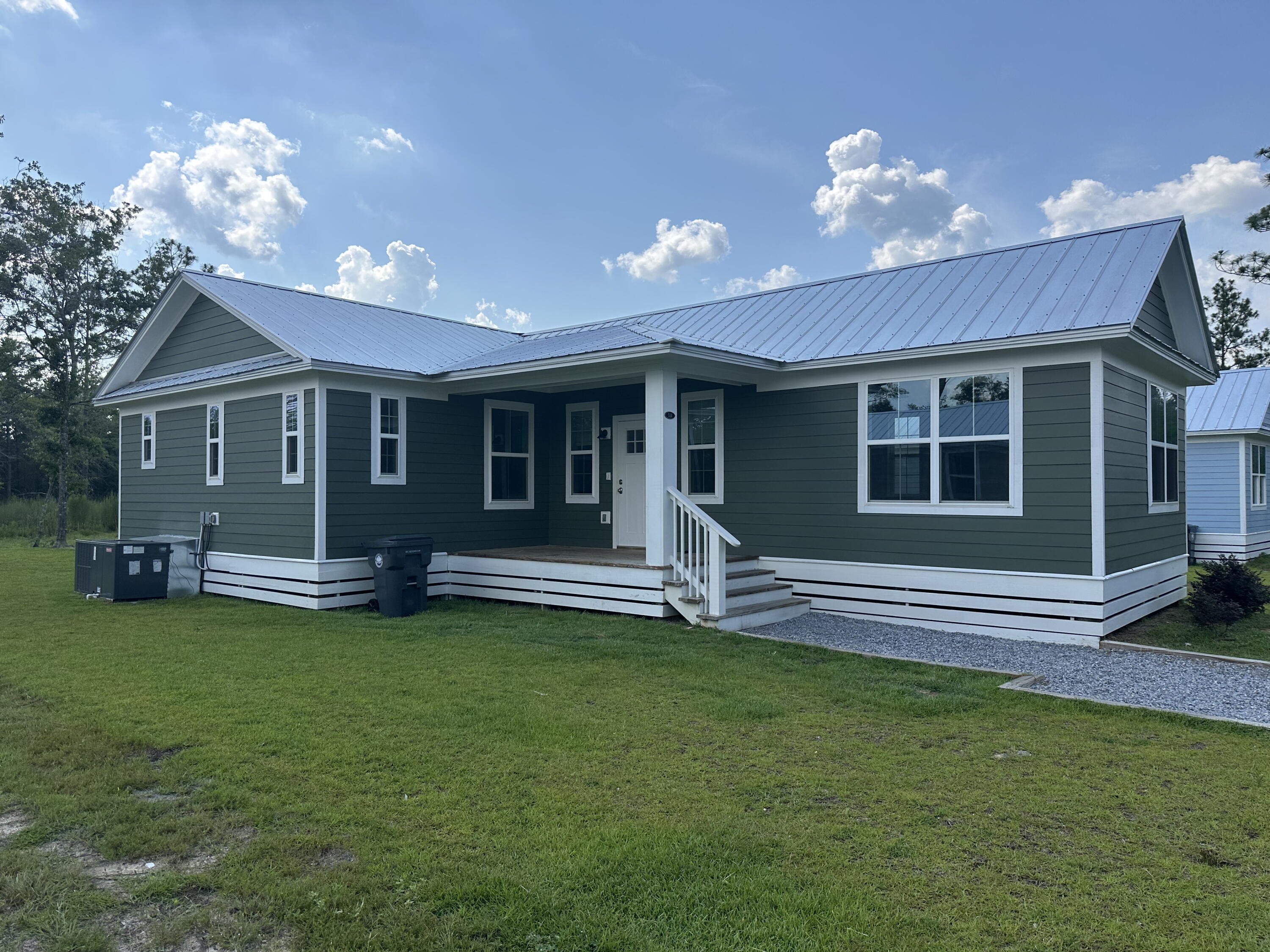 534 North Raphael Road DeFuniak Springs, FL 32433 - Photo 2 of 20 a view of a house with a patio and a yard