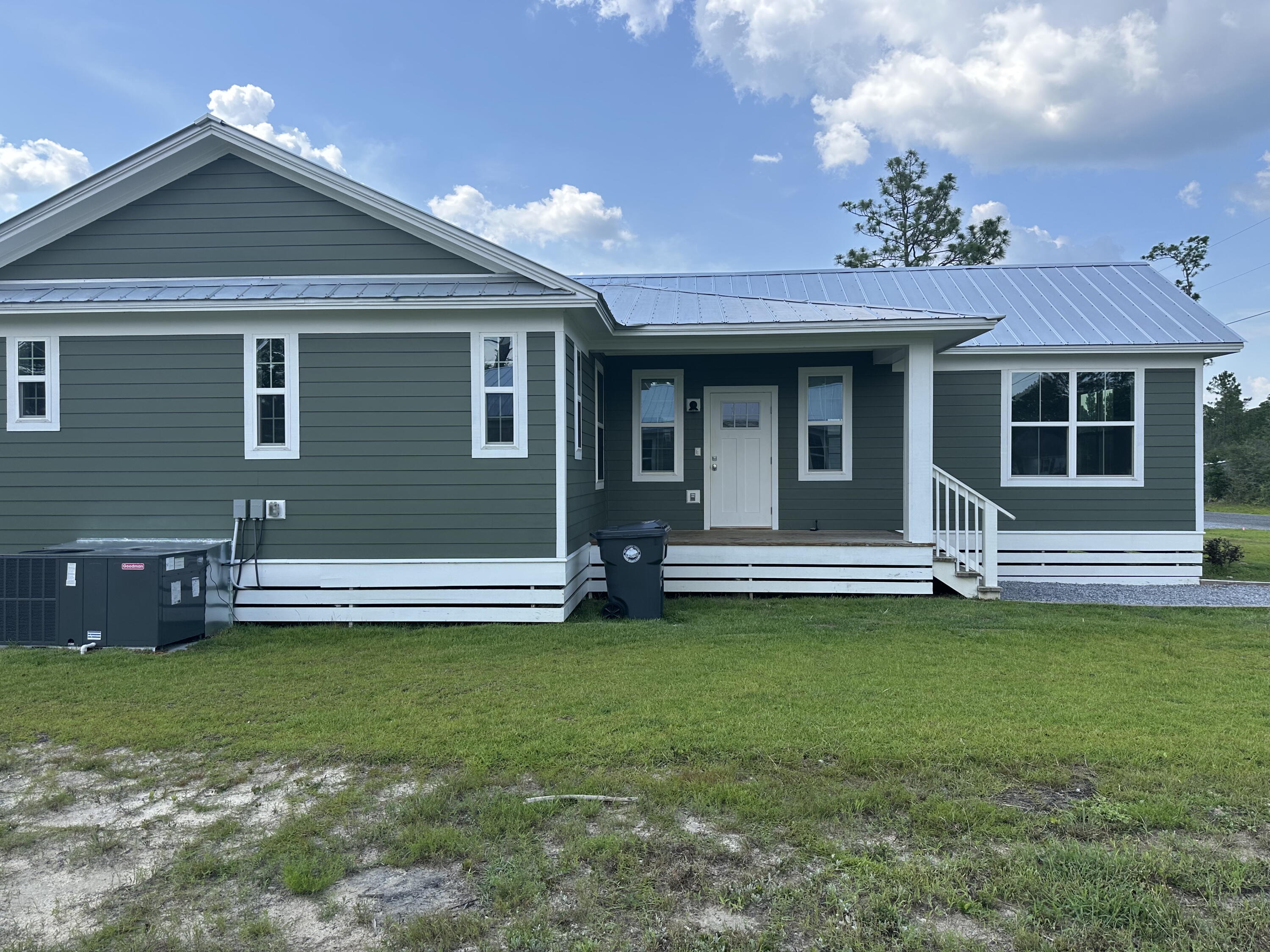534 North Raphael Road DeFuniak Springs, FL 32433 - Photo 3 of 20 a view of a house with a garden and plants