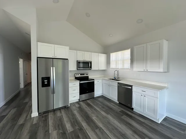 a kitchen with stainless steel appliances a refrigerator sink and stove
