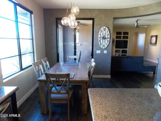 a view of a dining room with furniture and a large window