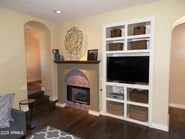 a living room with a fireplace and a flat screen tv