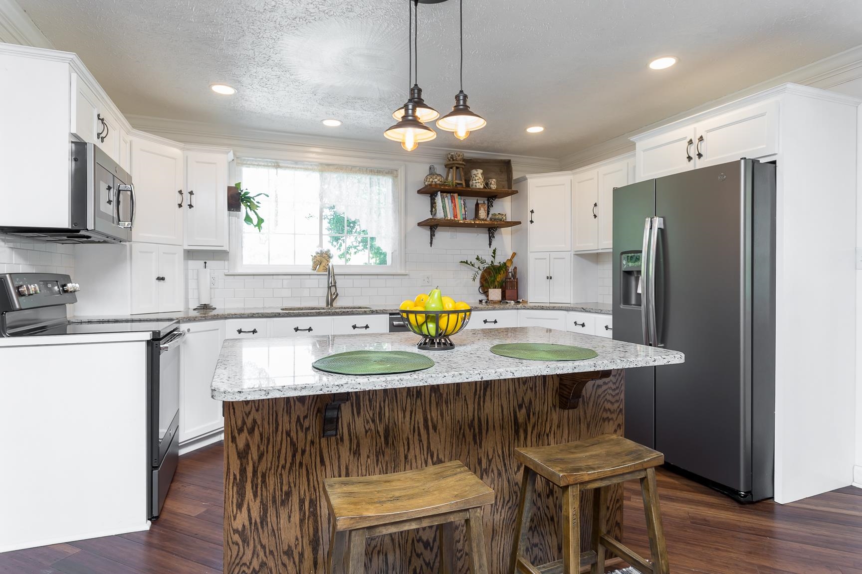 1099 Knightly Mill Road Mount Sidney, VA 24467 - Photo 34 of 60 a kitchen with stainless steel appliances granite countertop a sink a stove a refrigerator cabinets and a dining table