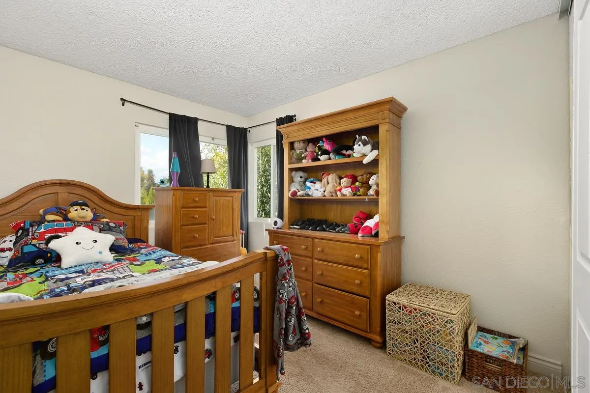10551 Cadwell Road Santee, CA 92071 - Photo 22 of 32 a bedroom with a bed and wooden floor