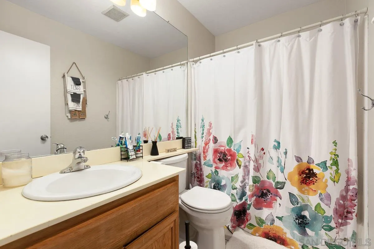10551 Cadwell Road Santee, CA 92071 - Photo 23 of 32 a bathroom with a sink toilet and a mirror