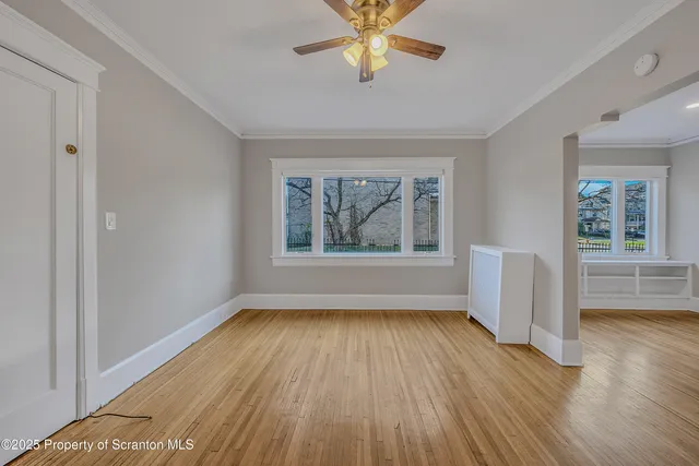 wooden floor in an empty room with a window