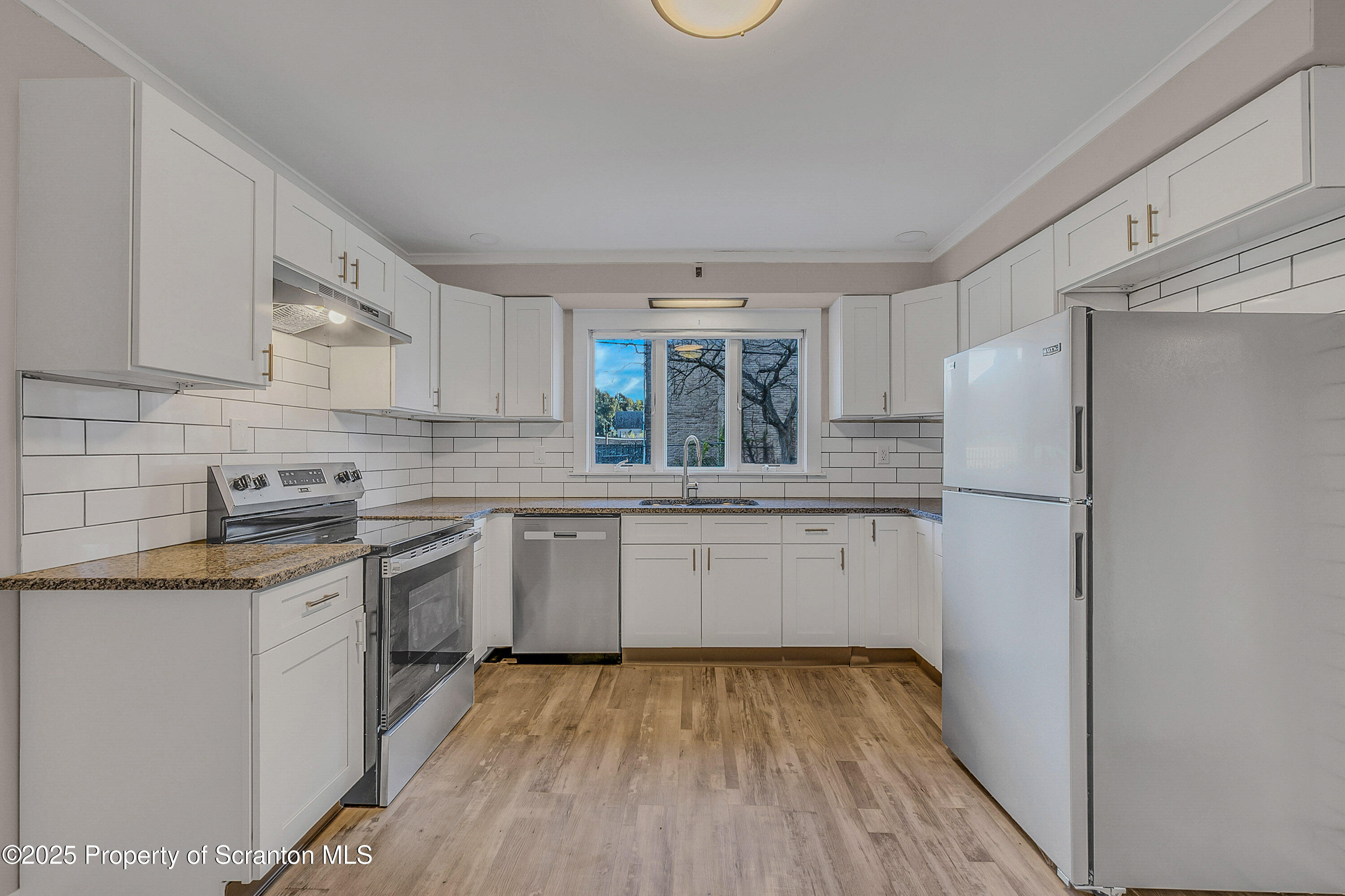 1900 North Washington Avenue, Unit 1 Scranton, PA 18509 - Photo 17 of 26 a kitchen with a sink a refrigerator and white cabinets