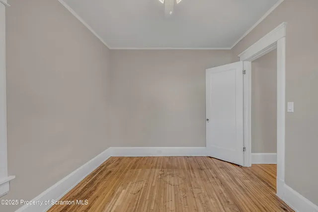 a view of a room with wooden floor