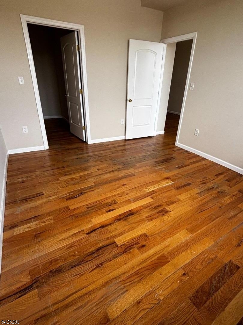 40 Broadway, Unit 5B Paterson, NJ 07505 - Photo 6 of 7 a view of an empty room with wooden floor