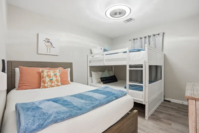 an aerial view of residential houses with outdoor space and trees