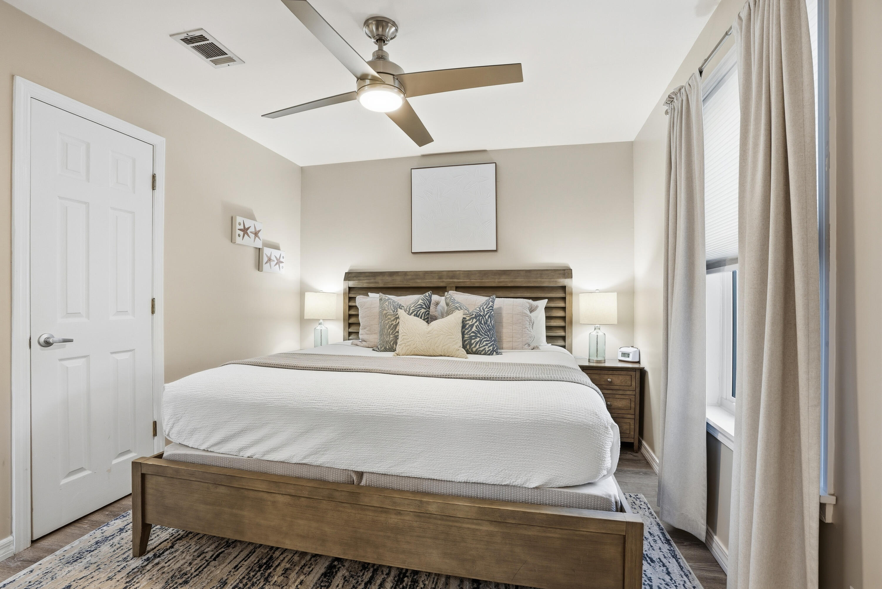 11 Beachside Drive, Unit 1214 Santa Rosa Beach, FL 32459 - Photo 21 of 28 a bedroom with a bed and a chandelier