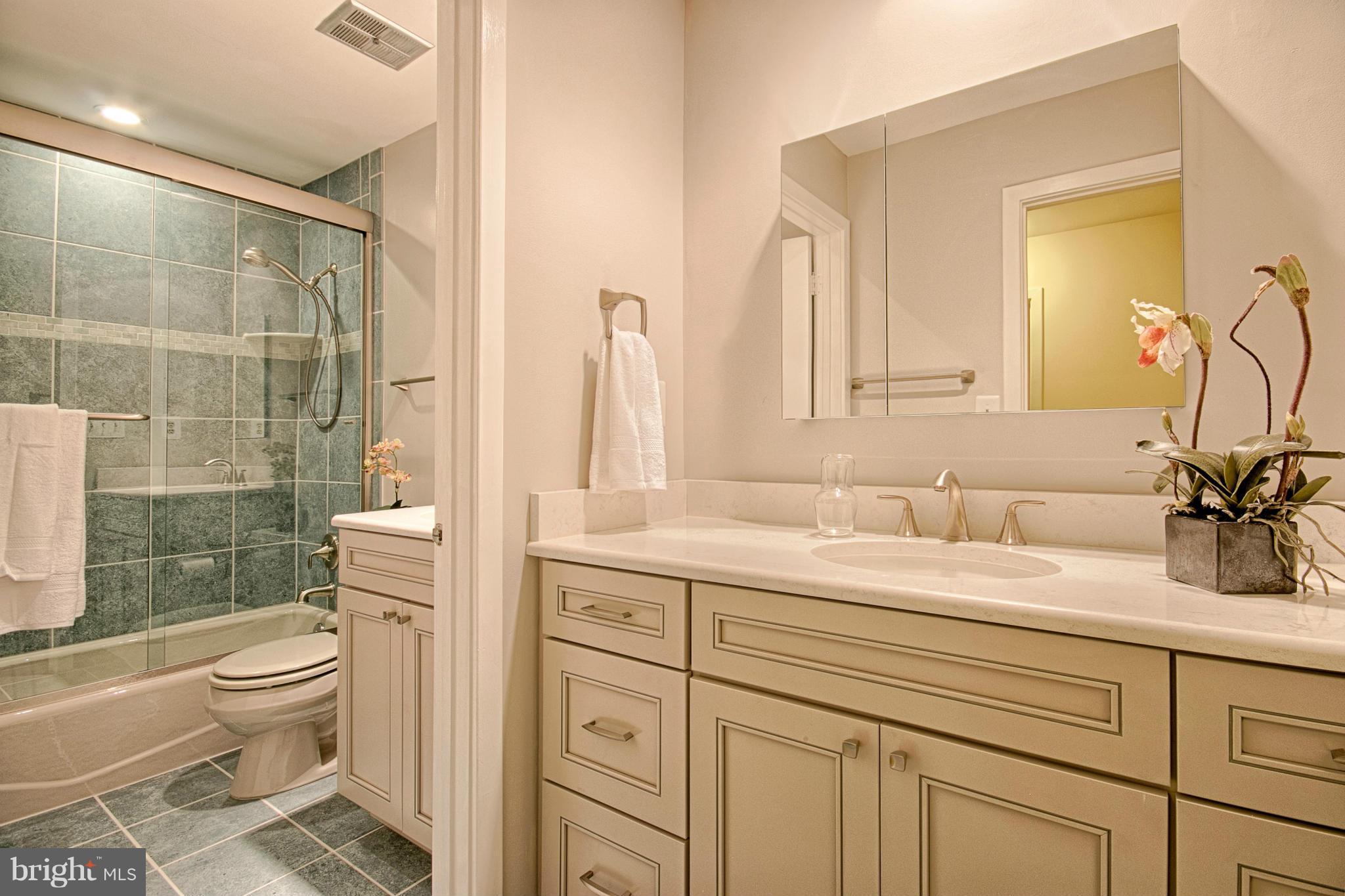 11404 Fieldstone Lane Reston, VA 20191 - Photo 22 of 30 a bathroom with a granite countertop sink toilet mirror and shower