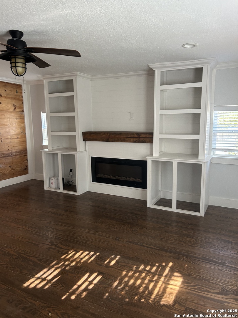 136 Phil Wilson Boerne, TX 78006 - Photo 5 of 7 a living room with hard wood floors and a fireplace