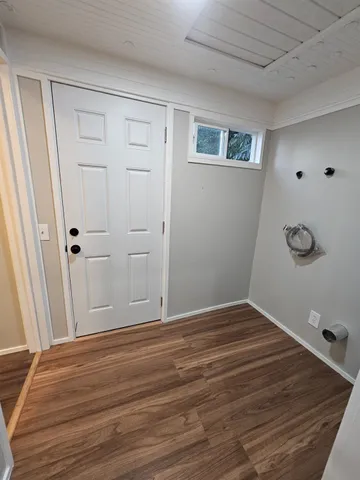 a view of a room with wooden floor