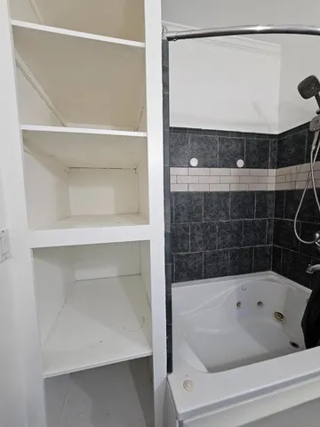 a very nice looking room with wooden floor and a window