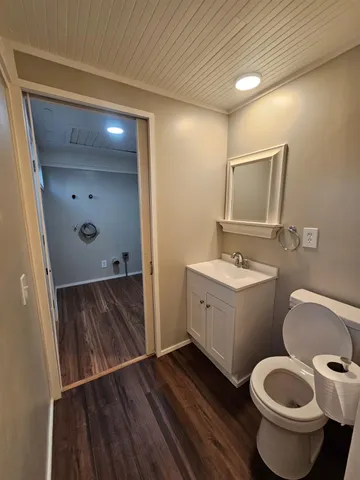 an empty room with wooden floor windows and ceiling fan