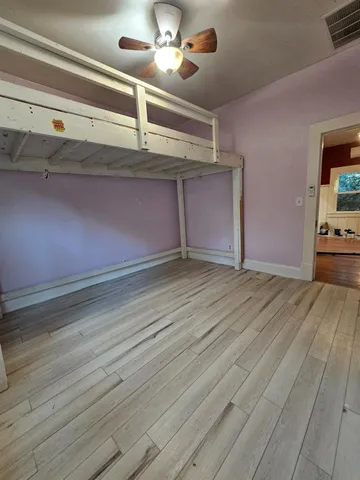 a view of an empty room and wooden floor