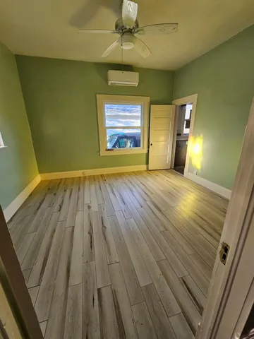 a view of a porch with wooden floor and outdoor space