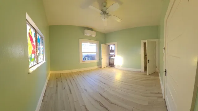a view of a backyard with potted plants and large trees