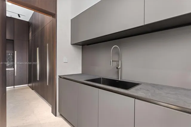 a spacious bedroom with a large bed and a flat tv screen on dresser