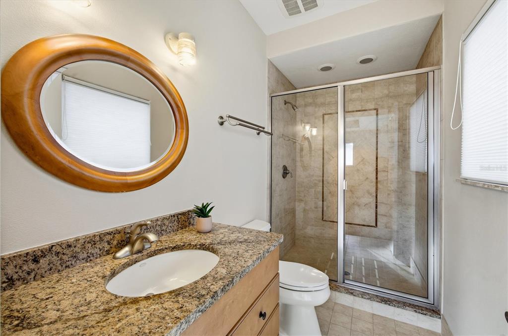 761 Norton Street Longboat Key, FL 34228 - Photo 29 of 66 a bathroom with a sink a toilet and a mirror