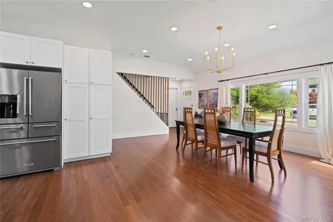 a kitchen with stainless steel appliances a refrigerator and wooden floor