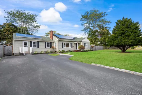 a view of house with yard and green space