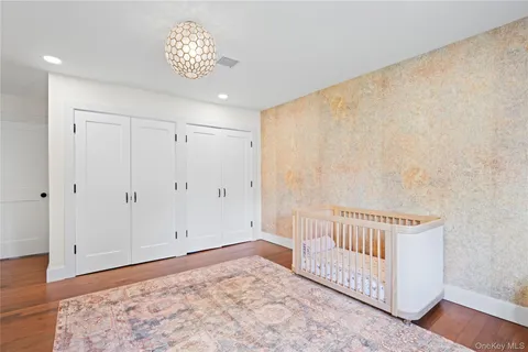 a spacious bedroom with a bed and a window