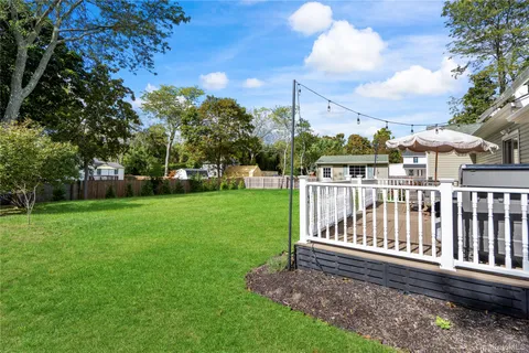 a view of a patio with a table chairs and a yard