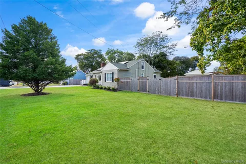 a view of an house with backyard space and garden