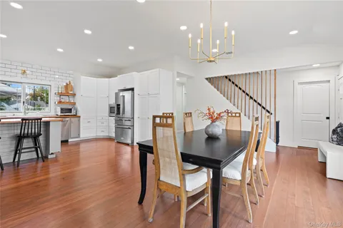 a dining room with furniture and wooden floor