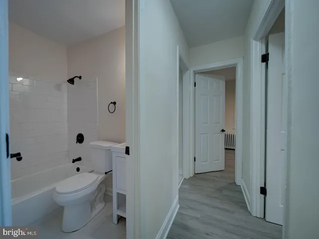 a bathroom with a toilet a sink and bathtub