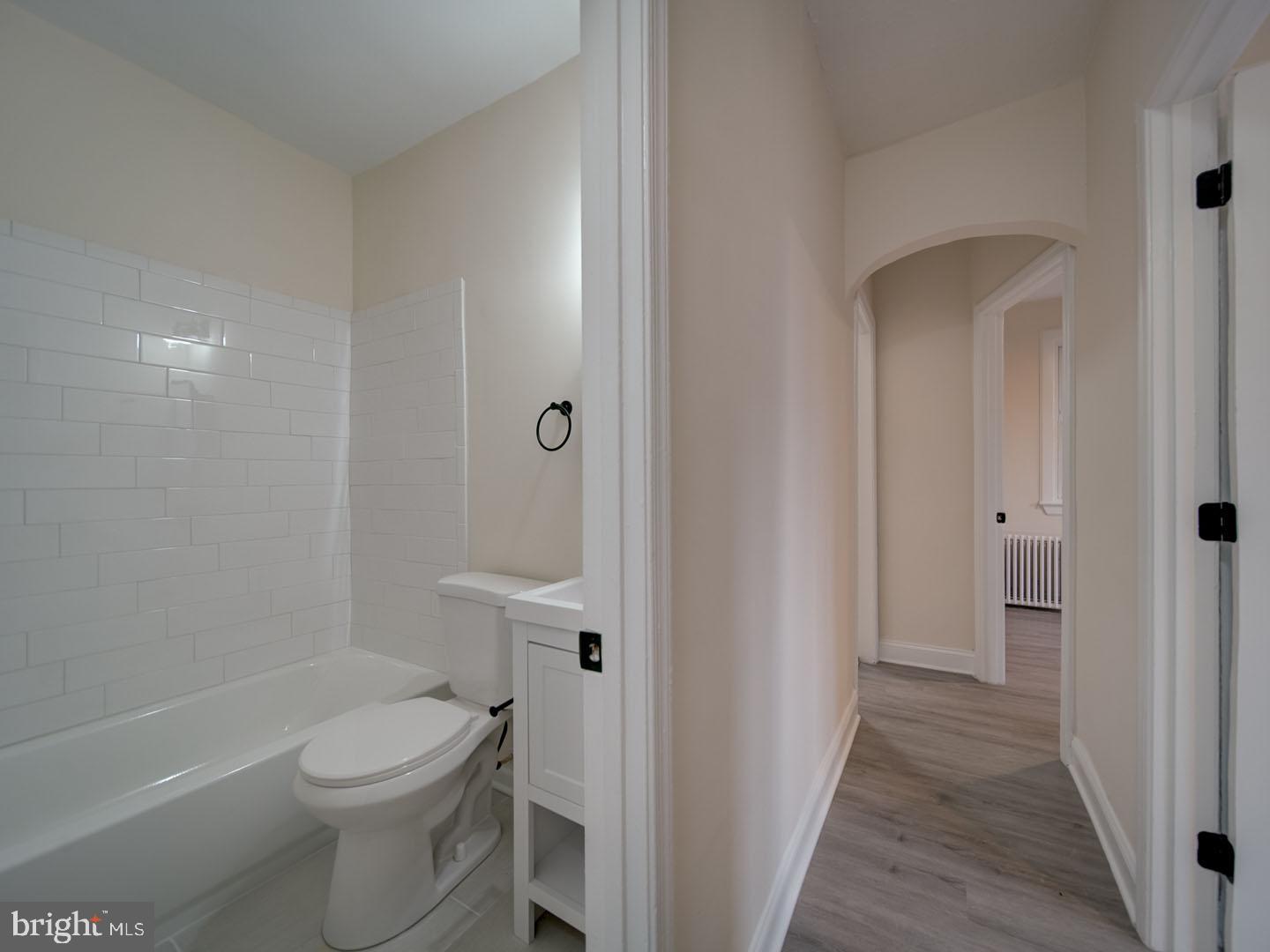 1946 I Street Northeast Washington, DC 20002 - Photo 34 of 47 a bathroom with a granite countertop toilet a sink and a bathtub