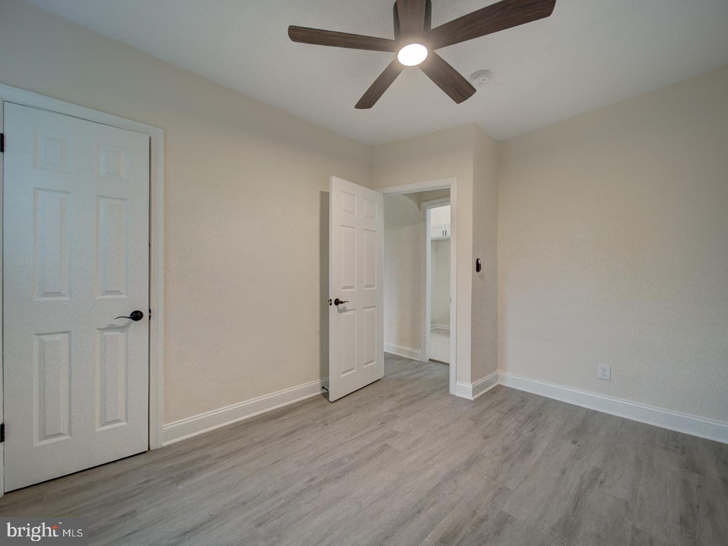 1946 I Street Northeast Washington, DC 20002 - Photo 42 of 47 an empty room with wooden floor and ceiling fan