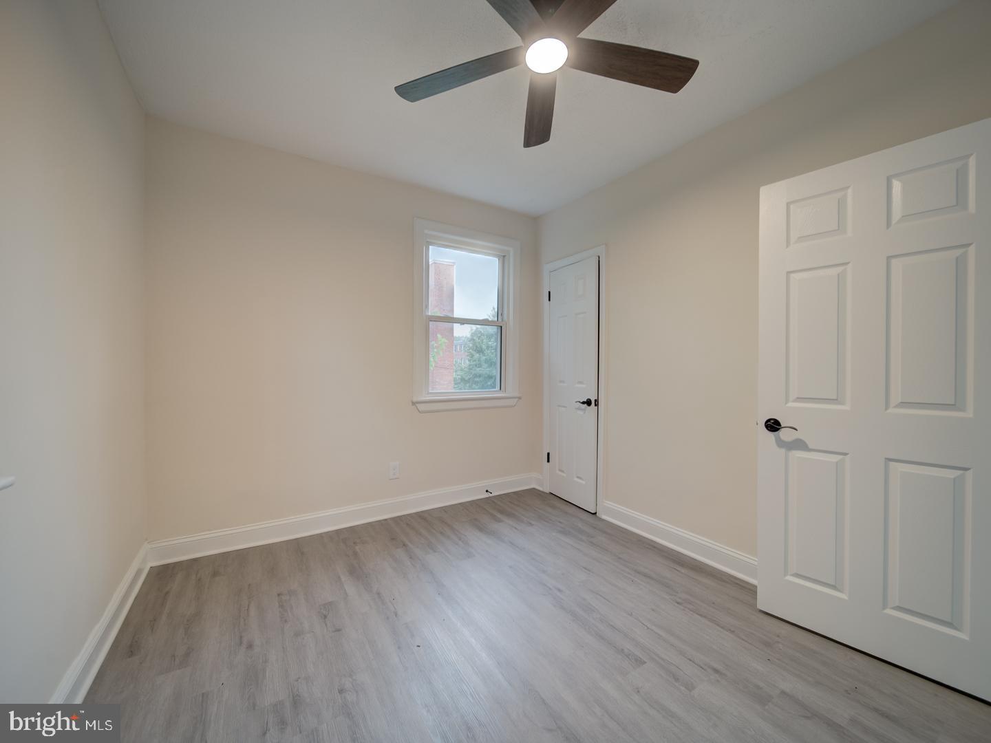 1946 I Street Northeast Washington, DC 20002 - Photo 44 of 47 an empty room with wooden floor chandelier fan and windows