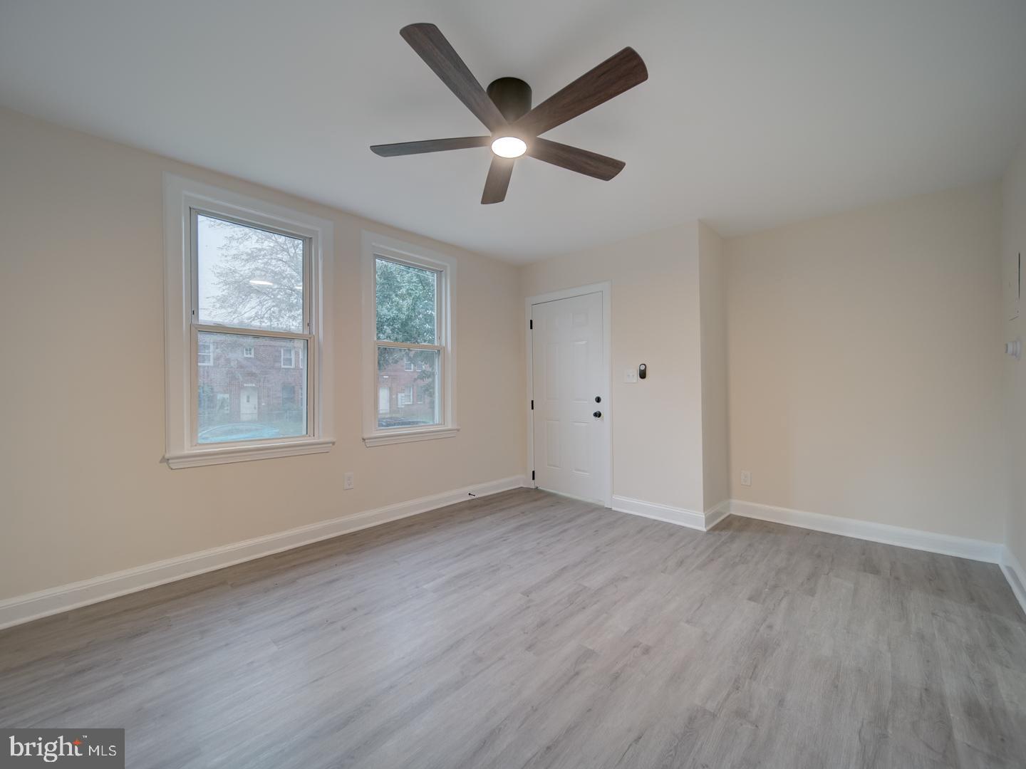 1946 I Street Northeast Washington, DC 20002 - Photo 8 of 47 a view of an empty room with wooden floor and a window