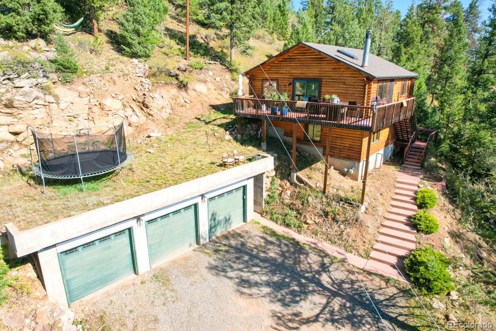10221 Blue Sky Trail Conifer, CO 80433 - Photo 11 of 37 a view of a chairs and table in the patio