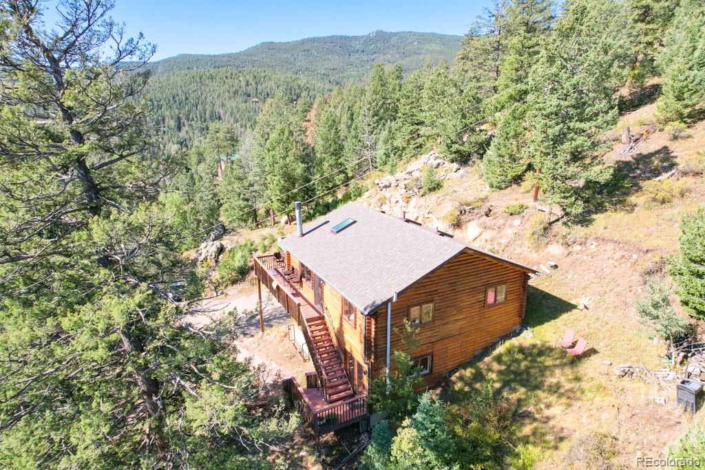 10221 Blue Sky Trail Conifer, CO 80433 - Photo 17 of 37 a view of a wooden wall with a mountain in the background