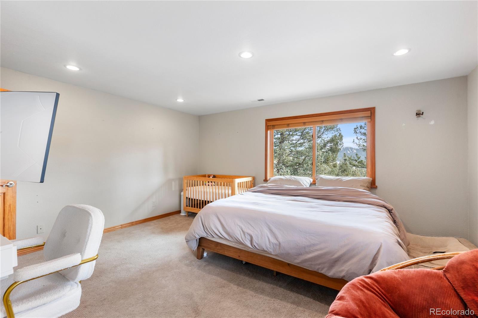10221 Blue Sky Trail Conifer, CO 80433 - Photo 27 of 37 a bedroom with a bed chair and window