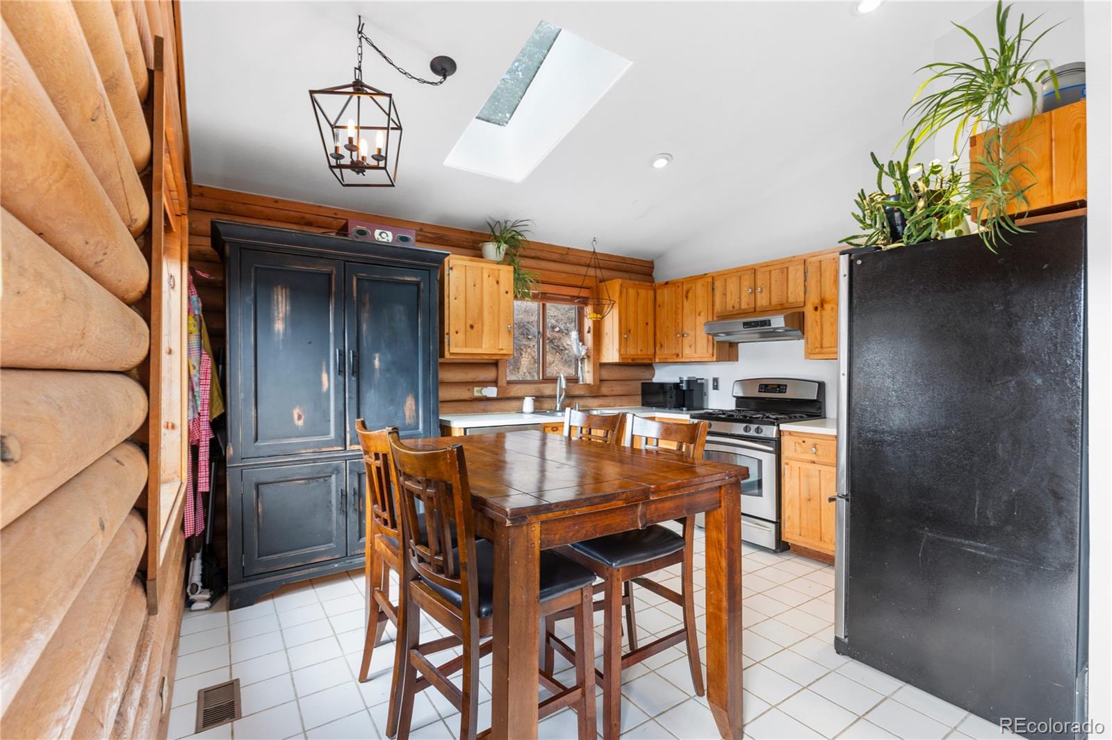 10221 Blue Sky Trail Conifer, CO 80433 - Photo 33 of 37 a dining room with furniture and a kitchen view