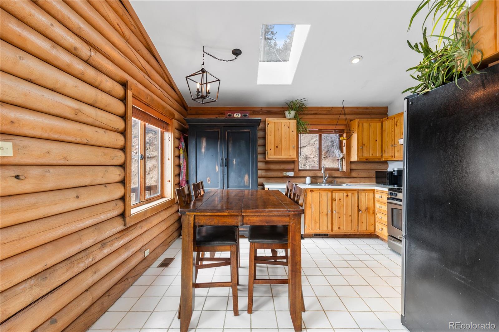 10221 Blue Sky Trail Conifer, CO 80433 - Photo 7 of 37 a large kitchen with a table and chairs
