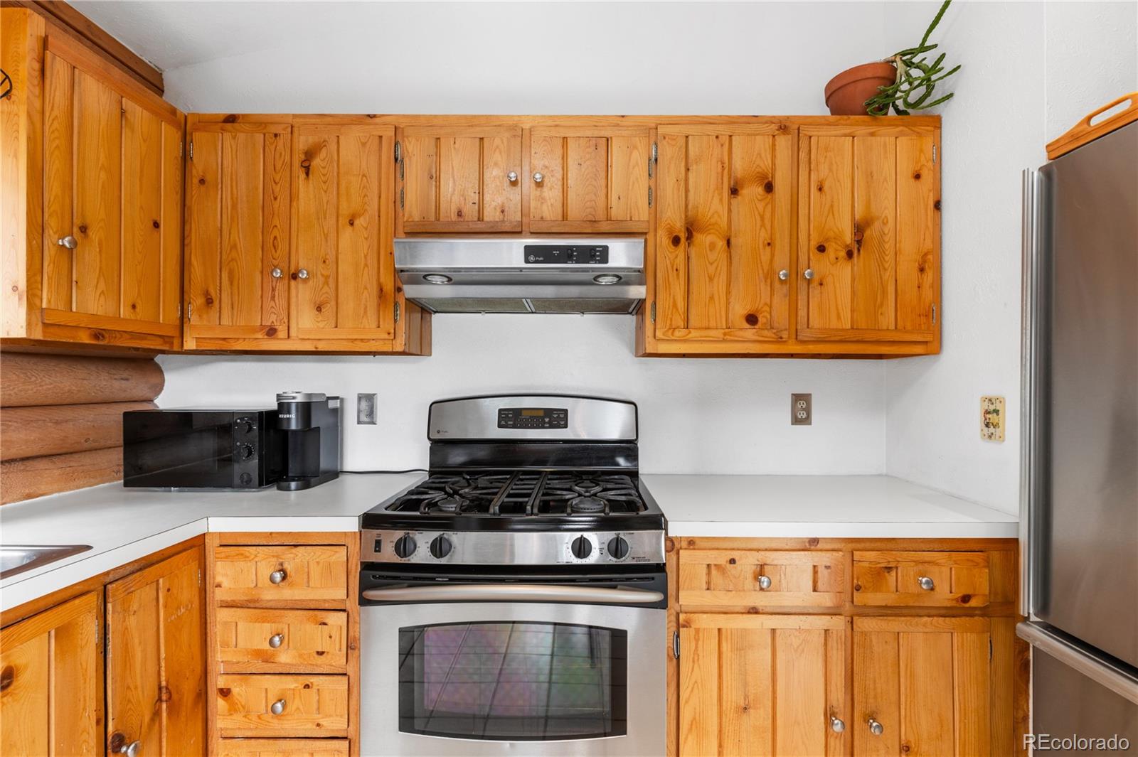10221 Blue Sky Trail Conifer, CO 80433 - Photo 10 of 37 a kitchen with stainless steel appliances granite countertop a stove a sink and a microwave