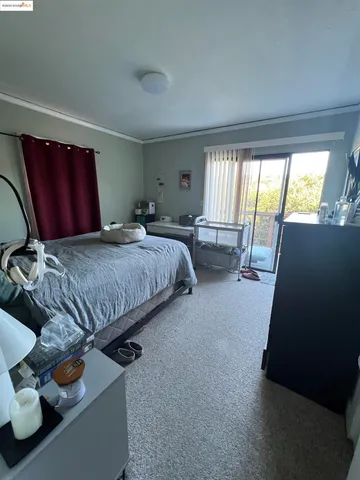 a bedroom with bed and window