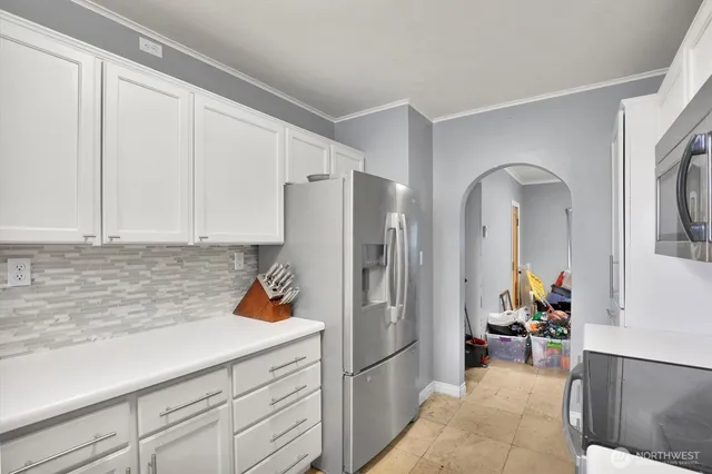a kitchen with stainless steel appliances granite countertop a refrigerator and a sink