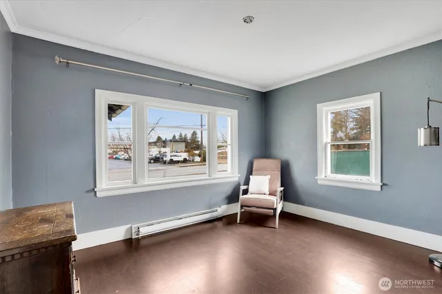 a living room with a window and a chair